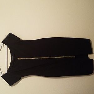 Black curve hugging dress .